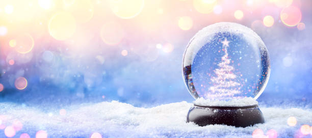 istock Shiny Christmas Tree In Snow Globe On Snow With Golden Lights 1185725954