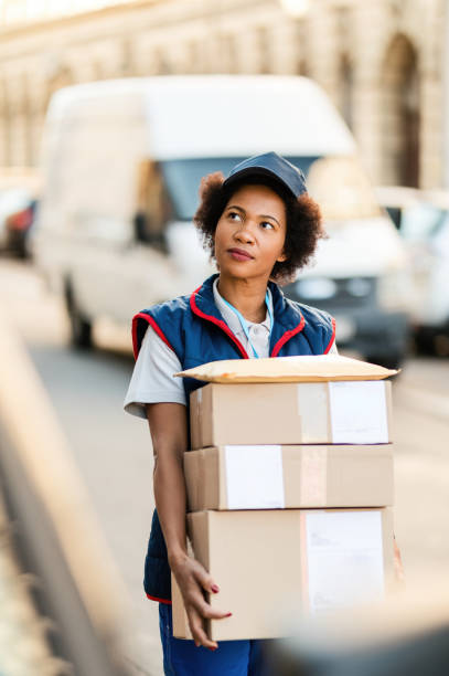 istock African American courier making a delivery in residential district. 1185726130