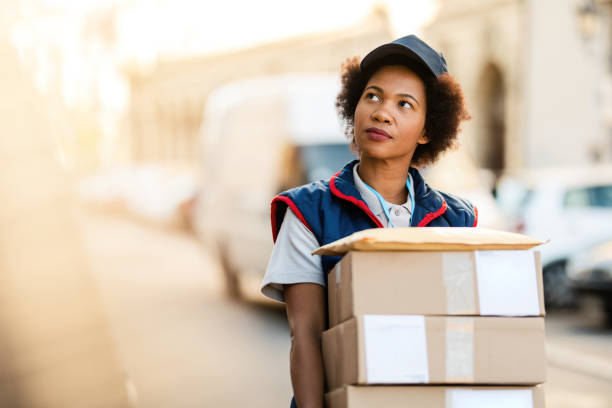 istock African American courier making a delivery in residential district. 1185726134