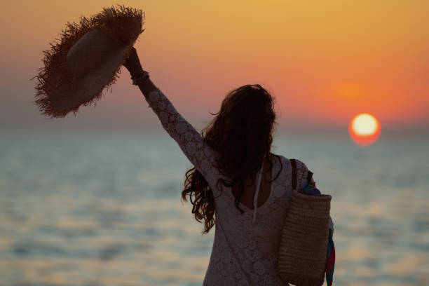 stylish woman with straw hat rejoicing