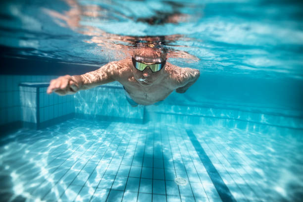 istock Senior man swimming in pool 1185726266