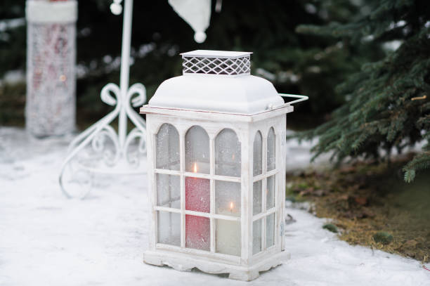 istock Christmas decorated lantern and candles on snow. 1185732898