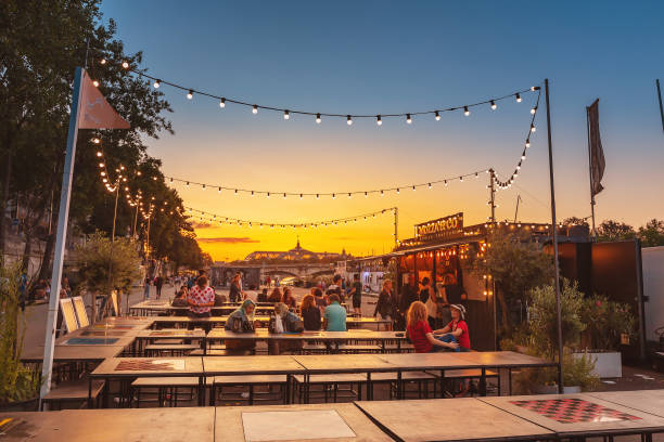 28 July 2019, Paris, France: Cafe on the promenade in Paris during sunset