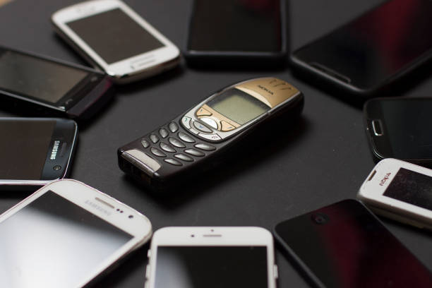 Milan, Italy - November 5, 2019: Close up on a group of smartphones resting on a black background