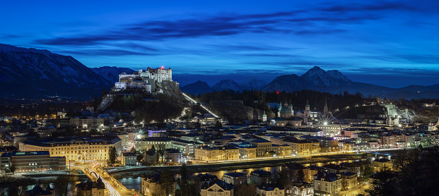 Pnaorama shot of the city of Salzburg at night with the brg in the background. long exposure in the blue hour