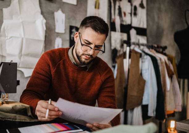 istock Male tailor sketching in clothing design studio 1185735903