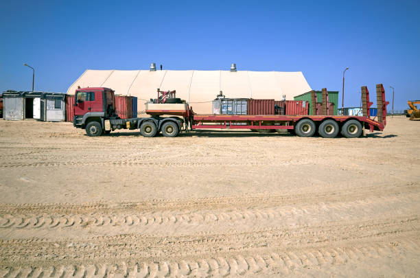 Trailer truck parking. Warehouse, technological area, sand, blue sky. Sakhalin, Russia