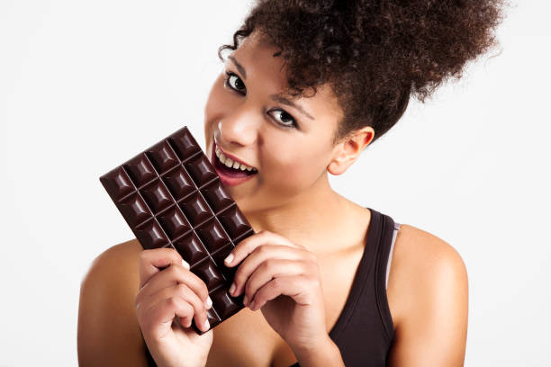 istock Woman eating chcolate 1185739251
