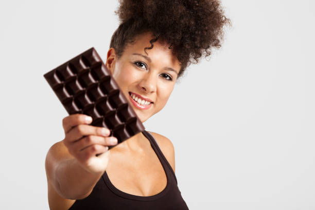 istock Woman with a chocolate bar 1185739256