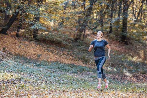 istock Woman running. Female runner jogging, training for marathon. 1185742475