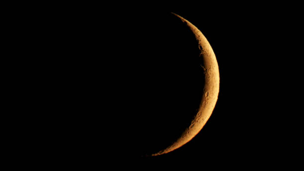 istock Waxing crescent moon seen with telescope 1185742583