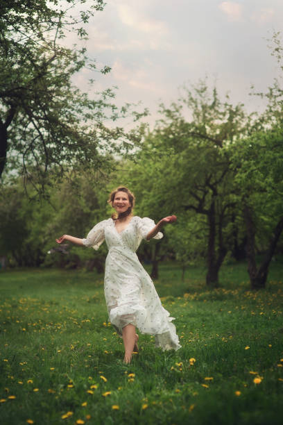 istock Attractive young woman in hat enjoying her time outdoors in spring park 1185745185