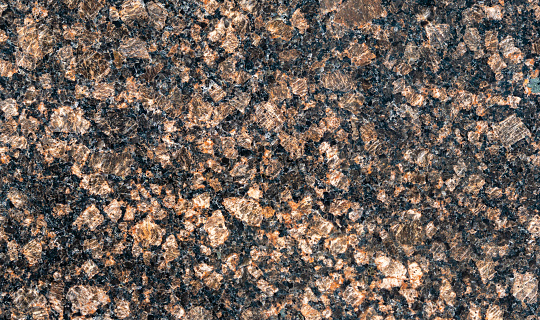 Polished granite as background to any disain. Close up of red marbled granite texture