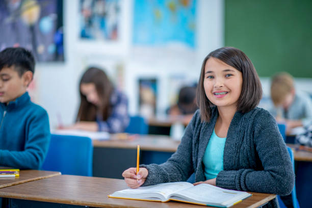 istock Elementary Girl With Textbook Open on Her Desk stock photo 1185750061