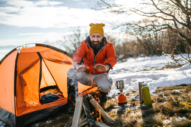 istock Hiker making some hot drink in winter camp 1185756952