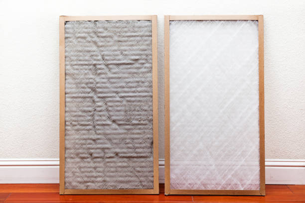 Dirty and Clean Air Conditioner Filters Old and New air conditioner filter next to each other leaning against the wall filtration stock pictures, royalty-free photos & images