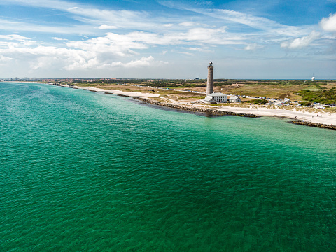 Aerial view of Skagen Lighthouse located in Grenen at Skagen Odde peninsula in Skagen, Denmark. Grenen marks the junction between the North Sea and the Kattegat sea.