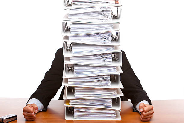 Business man depressed by paperwork (folders) stock photo