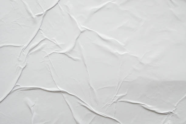 istock Blank white crumpled and creased paper poster texture background 1185760789