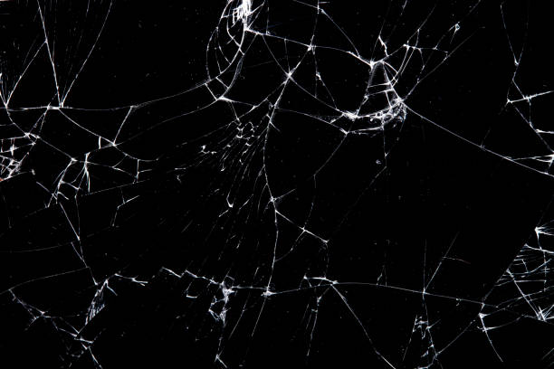 istock cracked glass isolated on a black background. 1185760932