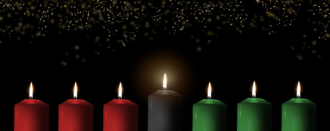 Kwanzaa for African-American cultural holiday celebration with candle light of seven candle sticks in black, green, red symbolising 7 principles of African Heritage (Nguzo Saba)