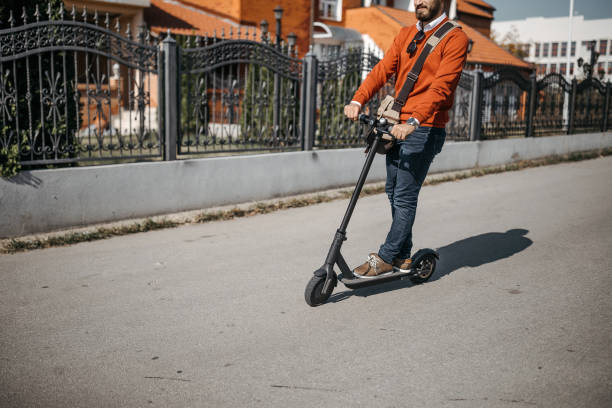 istock Man with electric scooter in city 1185765307