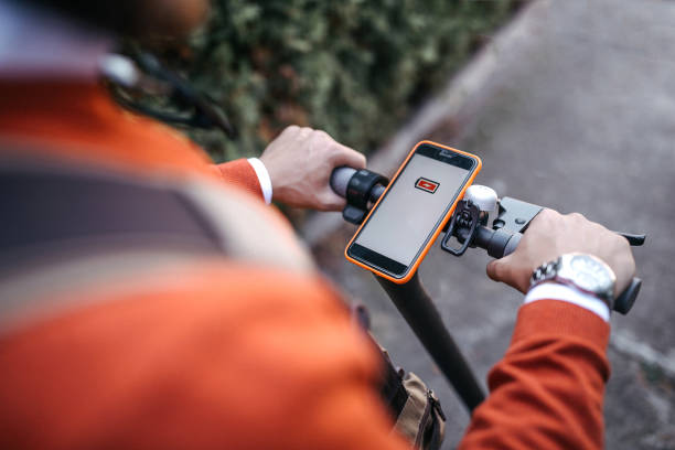 istock Man with electric scooter and mobile phone 1185765412