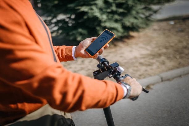 istock Man with electric scooter and mobile phone 1185765426