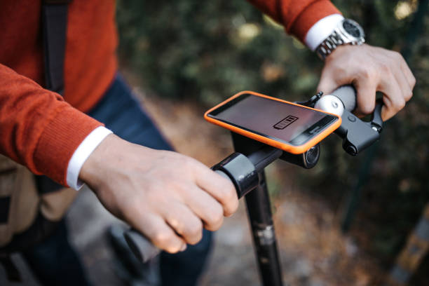 istock Man with electric scooter and mobile phone 1185765451