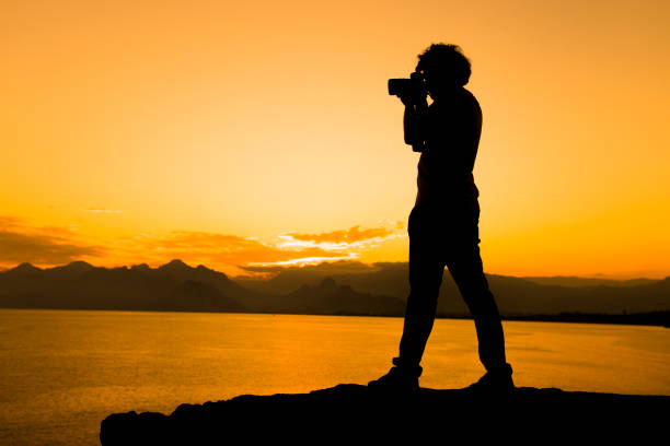 Silhouette Of Photographer In Sunset