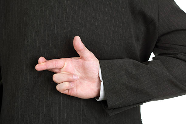 istock White collar worker telling a lie with fingers crossed 118576672