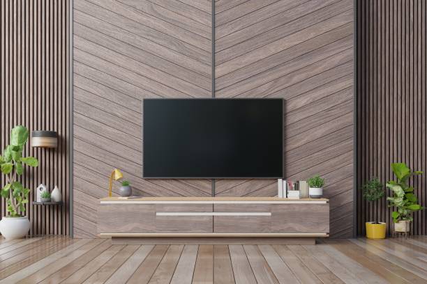 istock Smart Tv mockup hanging on herringbone wooden wall in modern interior. 1185768399