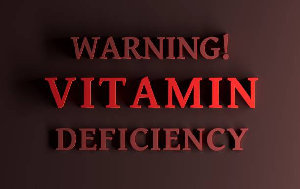 Message with bold red words Warning! Vitamin deficiency stock photo