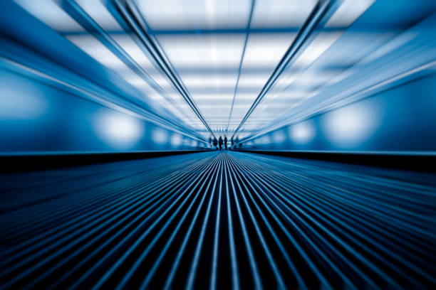 blurred motion of airport moving walkway, blue toned Building Exterior, Built Structure, City, Cityscape, Metal airport travelator stock pictures, royalty-free photos & images