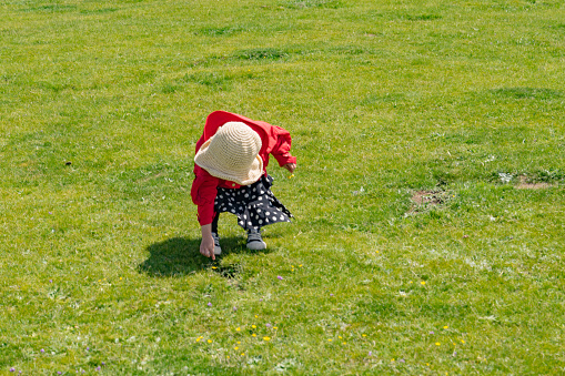 a young girl playing on the grass