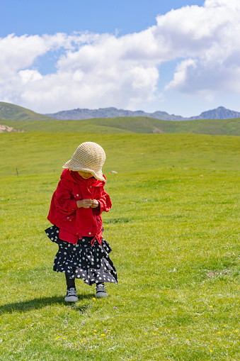 a young girl playing on the grass