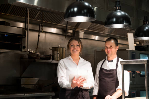 istock Hospitality team discussing menu on a tablet 1185773656