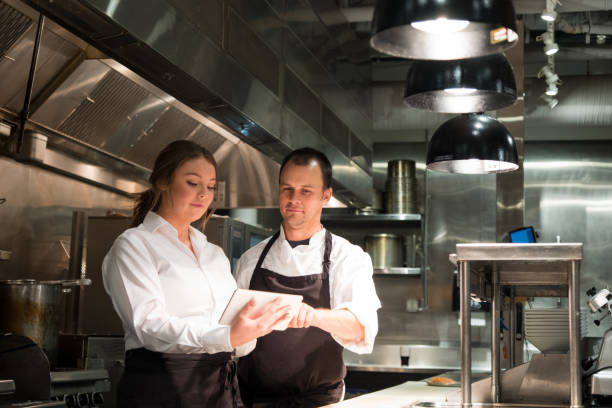 istock Hospitality team discussing menu options on a tablet 1185773665