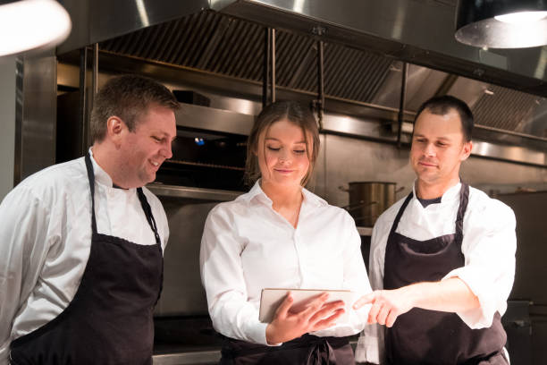 istock Hospitality team discussing menu on a tablet 1185773680