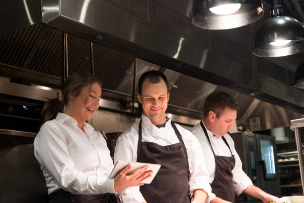 istock Hospitality team discussing menu on a tablet 1185773696