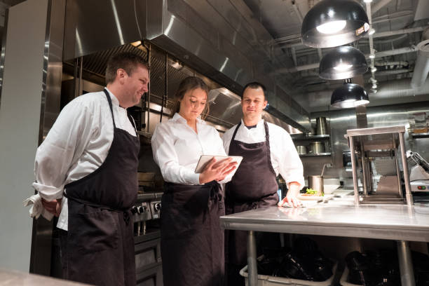istock Hospitality team discussing menu on a tablet 1185773714