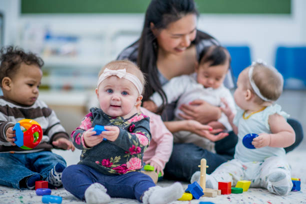 istock Daycare Worker Among Multi-Ethnic Babies stock photo 1185773827