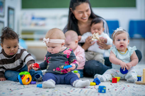 istock Daycare Worker Among Multi-Ethnic Babies stock photo 1185773836