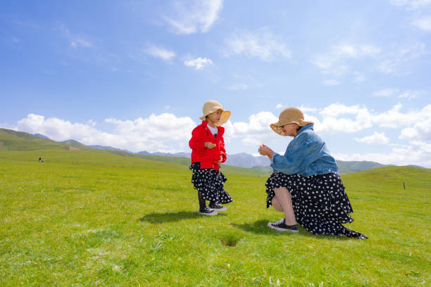 mother and daughter playing on the grass
