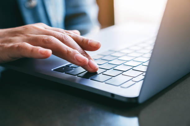 istock a woman's finger pressing on the enter button of laptop computer on the table 1185778254