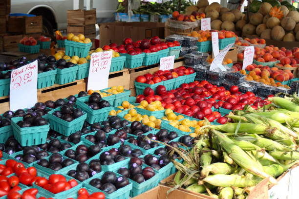 istock Fruit stand in a market with green baskets. 1185784071