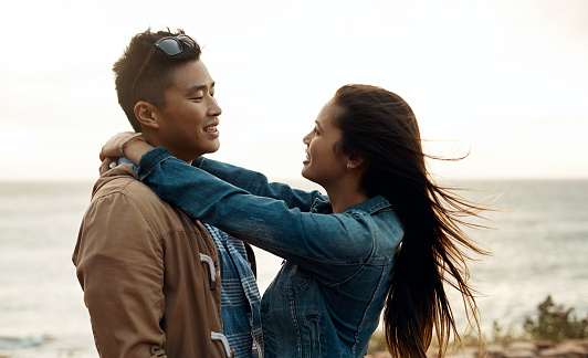 hot of a happy young couple sharing a romantic moment on a vacation along the coast