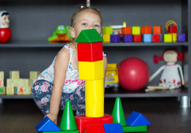 istock Little girl playing with big multicolor plastic blocks 1185790449