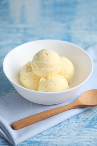 istock vanilla ice cream on a blue background with a blank space for a text, vanilla ice cream in white ceramic cup 1185793694