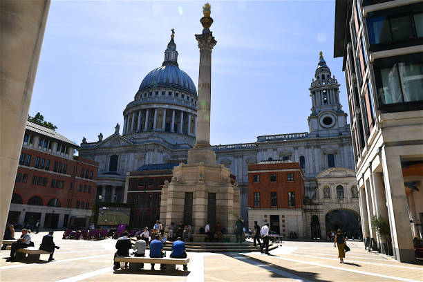 Paternoster square, London, UK. London, UK-07 04 2019:People on Paternoster square, which is an urban development, next to St Paul's Cathedral in the City of London. The area, which takes its name from Paternoster Row, once centre of the London publishing trade, was devastated by aerial bombardment in The Blitz during the Second World War. paternoster square stock pictures, royalty-free photos & images